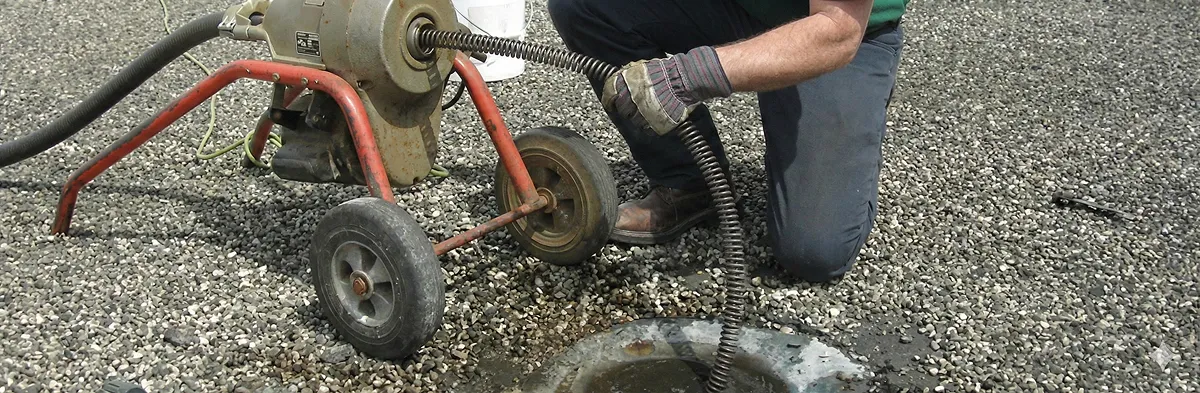 sewer rodding technician actively removing blockages from a sewer line in Miami, FL